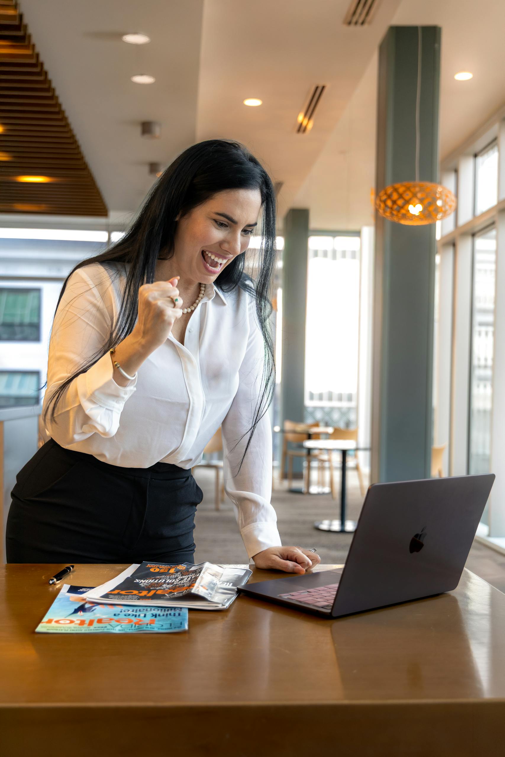 UAE woman in office in front of her laptop